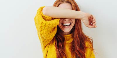 Beautiful woman playfully gesturing for silence